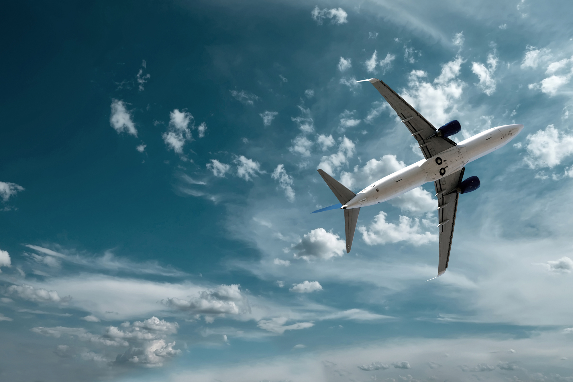 Airplane at fly on the sky with clouds