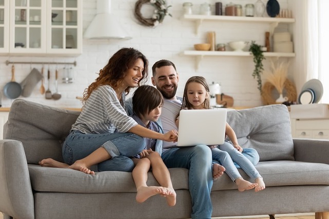 Happy,Young,Family,With,Little,Kids,Sit,On,Sofa,In