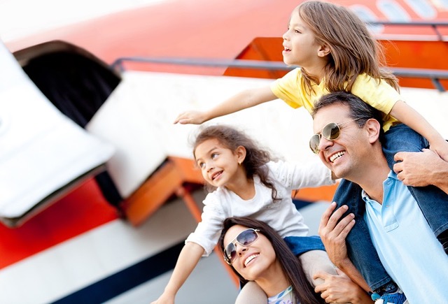 Excited,Family,With,Arms,Up,Traveling,By,Airplane