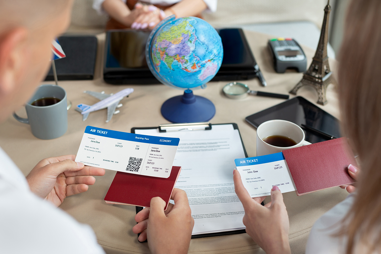 Close-up of passports and tickets in the hands of travelers at a travel agency